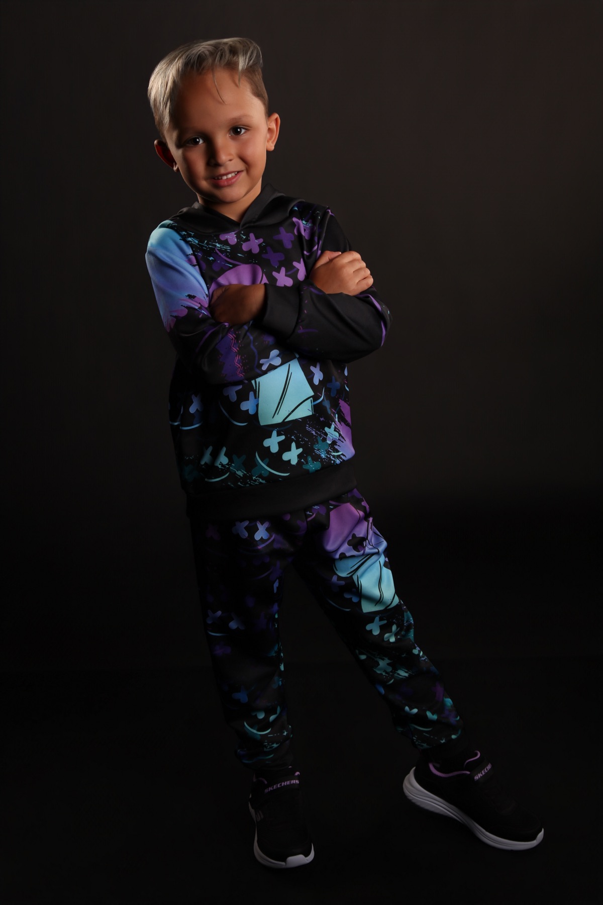 Neon look — purple and cyan graphic hoodie in dark studio